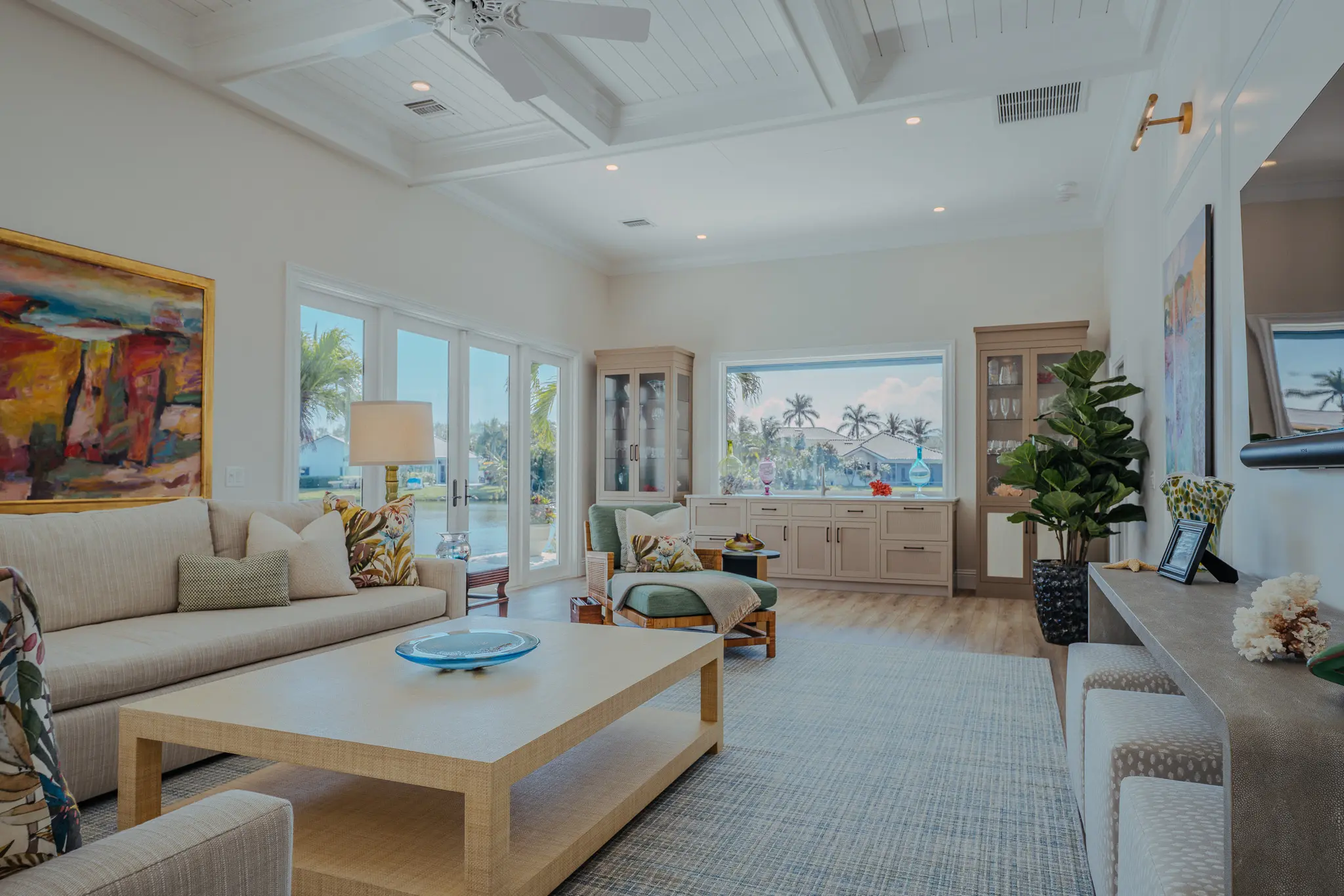 living room area with windows and door leading to pool area