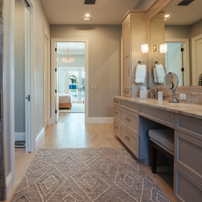 remodeled bathroom leading to bedroom with view of inlet